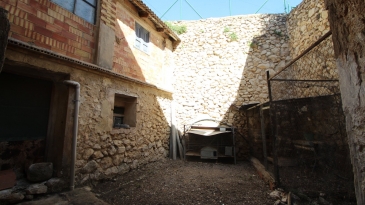 Large village house with stone patio.