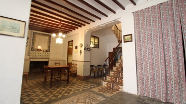 Large village house with stone patio.