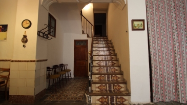 Large village house with stone patio.