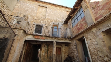 Large village house with stone patio.