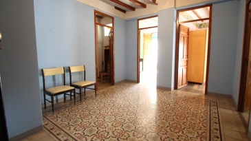 Large village house with stone patio.