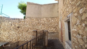 Large village house with stone patio.