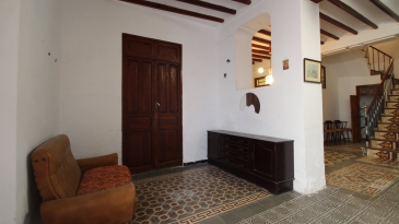 Large village house with stone patio.