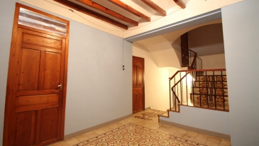 Large village house with stone patio.