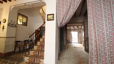Large village house with stone patio.