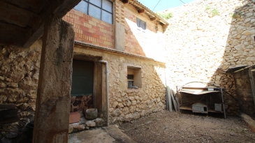 Large village house with stone patio.