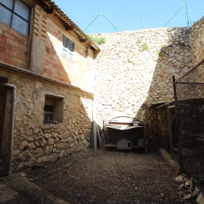 Large village house with stone patio.