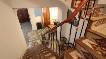 Large village house with stone patio.